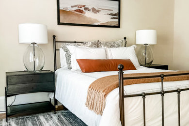 Mid-sized transitional medium tone wood floor bedroom photo in Charlotte with beige walls