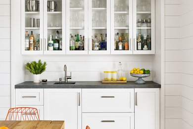 Farmhouse light wood floor home bar photo in Austin