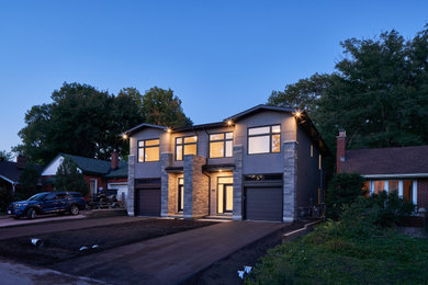 Example of a mid-sized minimalist gray two-story stone and clapboard exterior home design in Ottawa with a shingle roof and a black roof