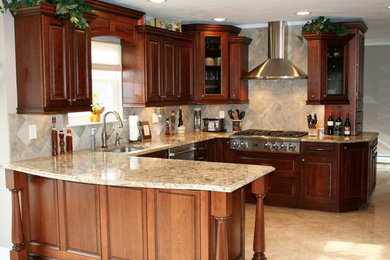 Example of a mid-sized classic u-shaped ceramic tile and beige floor open concept kitchen design in New York with an undermount sink, raised-panel cabinets, dark wood cabinets, granite countertops, beige backsplash, ceramic backsplash, stainless steel appliances and a peninsula