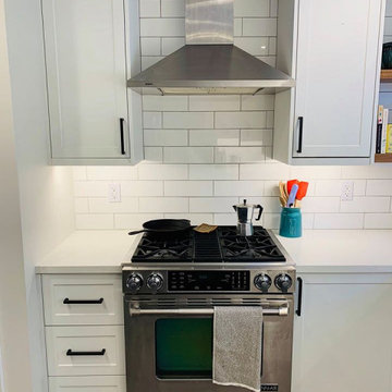 ikea white cabinets with subway tile backsplash and floating shelves