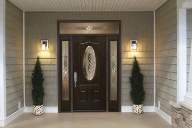 Inspiration for a mid-sized timeless single front door remodel in Denver with a dark wood front door
