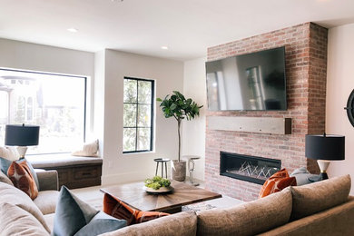 Example of a mid-sized danish walk-out basement design in Salt Lake City with a standard fireplace and a brick fireplace