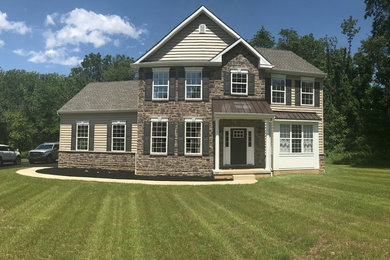 Large elegant beige two-story exterior home photo in Philadelphia