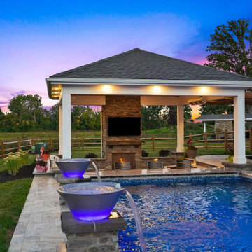 Pavilion with outdoor kitchen, gas fireplace and swim up bar.