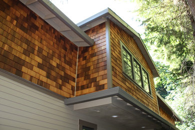 Photo of a mid-sized arts and crafts two-storey brown house exterior in Portland with wood siding.