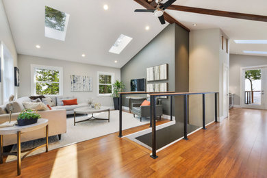 Inspiration for a small modern loft-style medium tone wood floor and brown floor living room remodel in San Francisco with brown walls, no fireplace and a wall-mounted tv