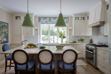 Enclosed kitchen - large traditional light wood floor enclosed kitchen idea in Boston with a farmhouse sink, recessed-panel cabinets, light wood cabinets, quartz countertops, multicolored backsplash, mosaic tile backsplash, paneled appliances, an island and beige countertops