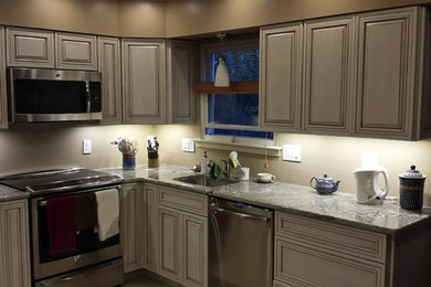 Open concept kitchen - mid-sized transitional l-shaped open concept kitchen idea in Newark with a single-bowl sink, beaded inset cabinets, marble countertops, stainless steel appliances and no island