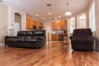 Example of a mid-sized classic enclosed light wood floor family room design in Orlando with no fireplace and a tv stand