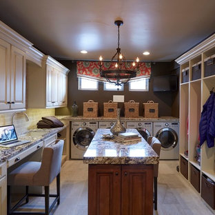 Photo of a large traditional separated utility room in Denver with a submerged sink, raised-panel cabinets, distressed cabinets, porcelain flooring and a side by side washer and dryer.