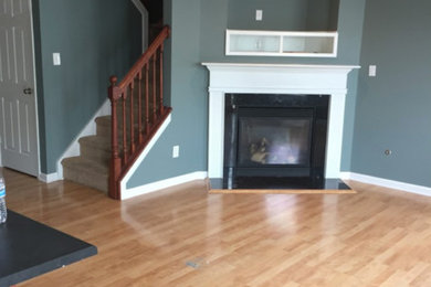 Family room - mid-sized traditional open concept family room idea in Indianapolis with gray walls, a corner fireplace and a wood fireplace surround