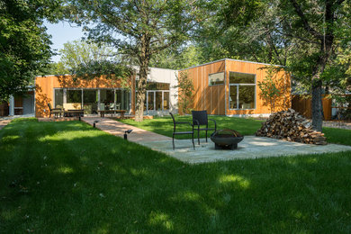 Mid-sized contemporary gray two-story wood house exterior idea in Other with a shed roof