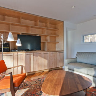 This is an example of a modern home cinema in Other with white walls, bamboo flooring and a built-in media unit.