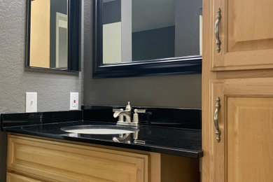 Bathroom - contemporary master bathroom idea in Los Angeles with raised-panel cabinets, light wood cabinets and granite countertops