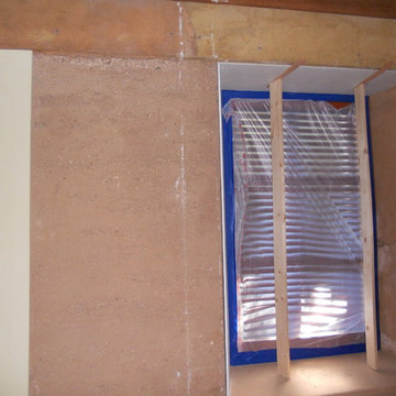 Adobe house dust control. Sheetrock level finish in bedroom.