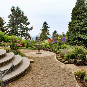 Gravel path with garden seating and layered borders