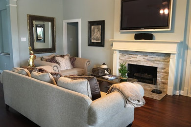 Living room library - mid-sized transitional open concept living room library idea in Houston with gray walls, a standard fireplace, a stone fireplace and a wall-mounted tv