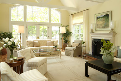 Living room - mid-sized traditional formal and open concept dark wood floor living room idea in New York with yellow walls, a standard fireplace, a plaster fireplace and no tv