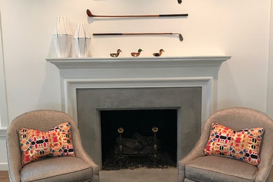 Inspiration for a large transitional formal and open concept medium tone wood floor living room remodel in Dallas with white walls, a standard fireplace, a concrete fireplace and a media wall