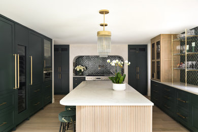 Example of a mid-sized transitional l-shaped light wood floor and beige floor eat-in kitchen design in DC Metro with an undermount sink, shaker cabinets, green cabinets, quartz countertops, green backsplash, ceramic backsplash, stainless steel appliances, an island and white countertops