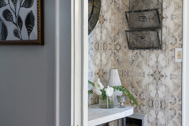 Small eclectic medium tone wood floor and brown floor foyer photo in New York with multicolored walls