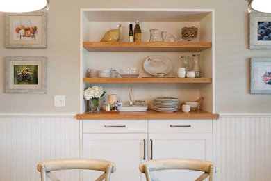 Example of a mid-sized beach style light wood floor and brown floor enclosed dining room design in Boston with gray walls and no fireplace