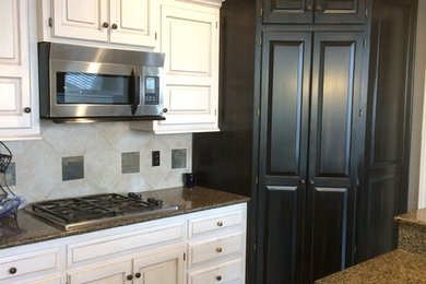 Open concept kitchen - large traditional l-shaped medium tone wood floor open concept kitchen idea in Little Rock with raised-panel cabinets, white cabinets, granite countertops, multicolored backsplash, ceramic backsplash, stainless steel appliances and an island