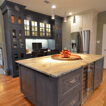 View over island toward custom built cabinetry with workstation