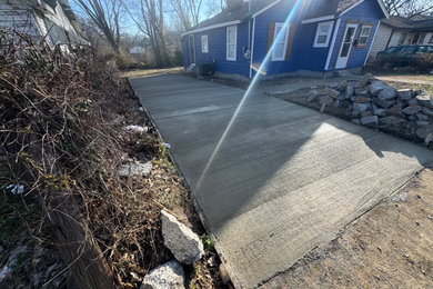 Photo of a mid-sized industrial full sun front yard driveway in Other for summer.