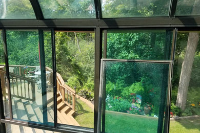 Mid-sized elegant sunroom photo in Detroit with a glass ceiling
