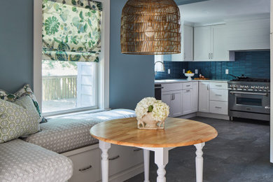 Mid-sized transitional vinyl floor and gray floor kitchen photo in Other with an undermount sink, shaker cabinets, white cabinets, quartz countertops, blue backsplash, glass tile backsplash, stainless steel appliances and white countertops