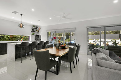 Design ideas for a large contemporary open plan dining in Brisbane with white walls, porcelain floors and beige floor.
