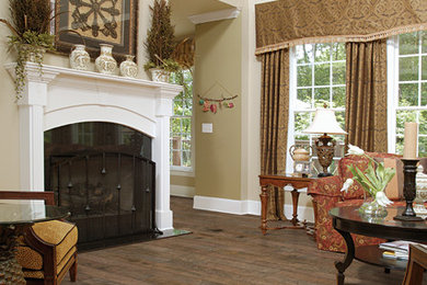 Mid-sized elegant enclosed medium tone wood floor and brown floor living room photo in Denver with white walls, a standard fireplace and a wood fireplace surround