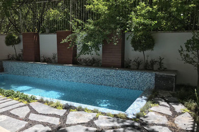 This is an example of a small rustic partial sun backyard stone formal garden in Other for spring.