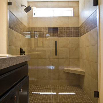 tiled shower with stripe, linear drain, and corner seat