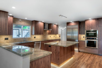 Large minimalist u-shaped light wood floor and brown floor eat-in kitchen photo in San Francisco with a single-bowl sink, flat-panel cabinets, granite countertops, beige backsplash, stone tile backsplash, stainless steel appliances, an island and medium tone wood cabinets