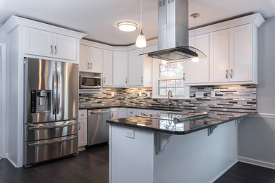 Design ideas for a mid-sized transitional u-shaped eat-in kitchen in Raleigh with an undermount sink, shaker cabinets, white cabinets, quartz benchtops, multi-coloured splashback, matchstick tile splashback, stainless steel appliances, dark hardwood floors, a peninsula and brown floor.
