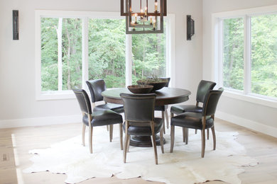 Huge mountain style light wood floor great room photo in Cedar Rapids with gray walls and no fireplace