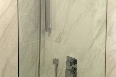 Photo of a small contemporary bathroom in Vancouver with a drop-in tub, a shower/bathtub combo and white tile.