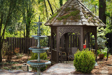 Large traditional backyard patio in Birmingham with a water feature, brick pavers and a gazebo/cabana.