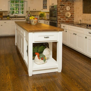 Large farmhouse kitchen pantry photos - Kitchen pantry - large country u-shaped medium tone wood floor and brown floor kitchen pantry idea in Richmond with a drop-in sink, shaker cabinets, white cabinets, granite countertops, beige backsplash, travertine backsplash, stainless steel appliances and an island