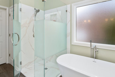 Bathroom - mid-sized coastal master white tile and stone slab linoleum floor, beige floor, double-sink and shiplap wall bathroom idea in Wilmington with white cabinets, green walls, an undermount sink, quartz countertops, a hinged shower door, white countertops and a built-in vanity