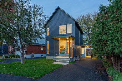 Inspiration for a mid-sized modern two-storey blue house exterior in Ottawa with concrete fiberboard siding, a gable roof, a shingle roof, a grey roof and shingle siding.