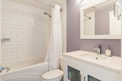 Bathroom - mid-sized modern white tile and subway tile bathroom idea in Vancouver with a one-piece toilet, glass-front cabinets, white cabinets, purple walls, an integrated sink and marble countertops