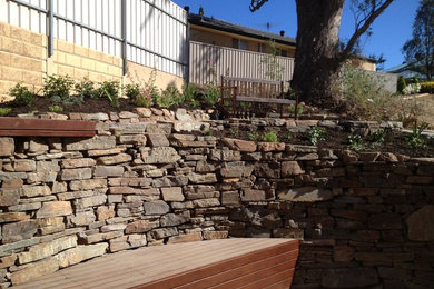 Mid-sized modern sloped garden in Adelaide with a retaining wall.