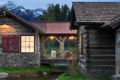 Mountain style side porch photo in Other with a roof extension