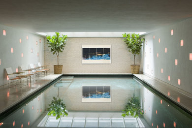 Example of a large minimalist indoor tile and rectangular pool design in New York