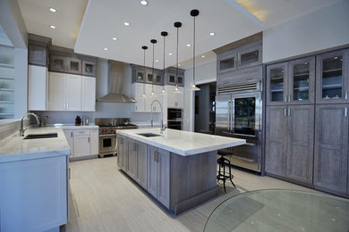 Large contemporary kitchen in DC Metro with shaker cabinets, distressed cabinets, marble benchtops, stainless steel appliances, porcelain floors, with island and grey floor.