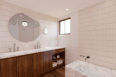 Inspiration for a large 1950s master beige tile dark wood floor, brown floor and double-sink bathroom remodel in Orange County with flat-panel cabinets, dark wood cabinets, a one-piece toilet, beige walls, a drop-in sink, marble countertops and a built-in vanity